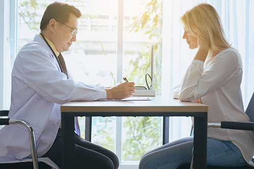 Psychiatrist and patient talking in a mental health practice