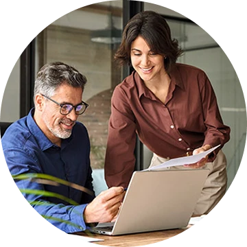 Striven referral program - people from the referring company look at a laptop screen together in an office