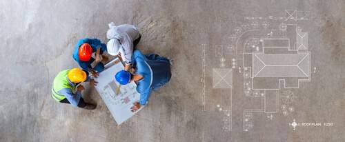 construction professionals communicating over blueprint